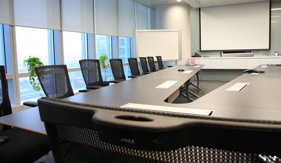 conference room with screen and smart shades