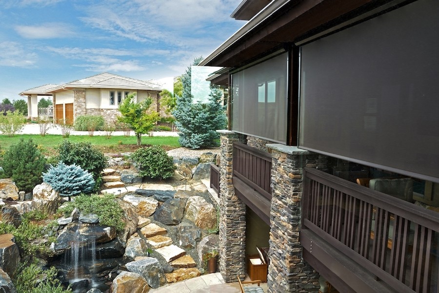 A patio with an automated outdoor screen.